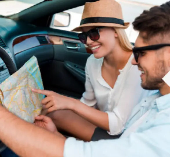 A couple looking at a map on a road trip